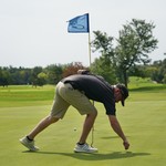 Fixin the ball mark. He damn near backed that thing up right into the hole.