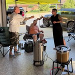 Toasting a successful brew day with a taste of the last batch of homebrew