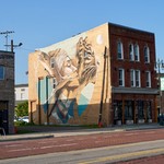 A cool mural between a a tavern and the police athletic league